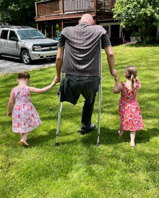 Willard Barth walking with his granddaughters